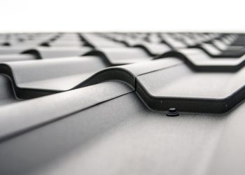 Close-up view of a metal roofs wavy design showcasing rivets and structural detail.